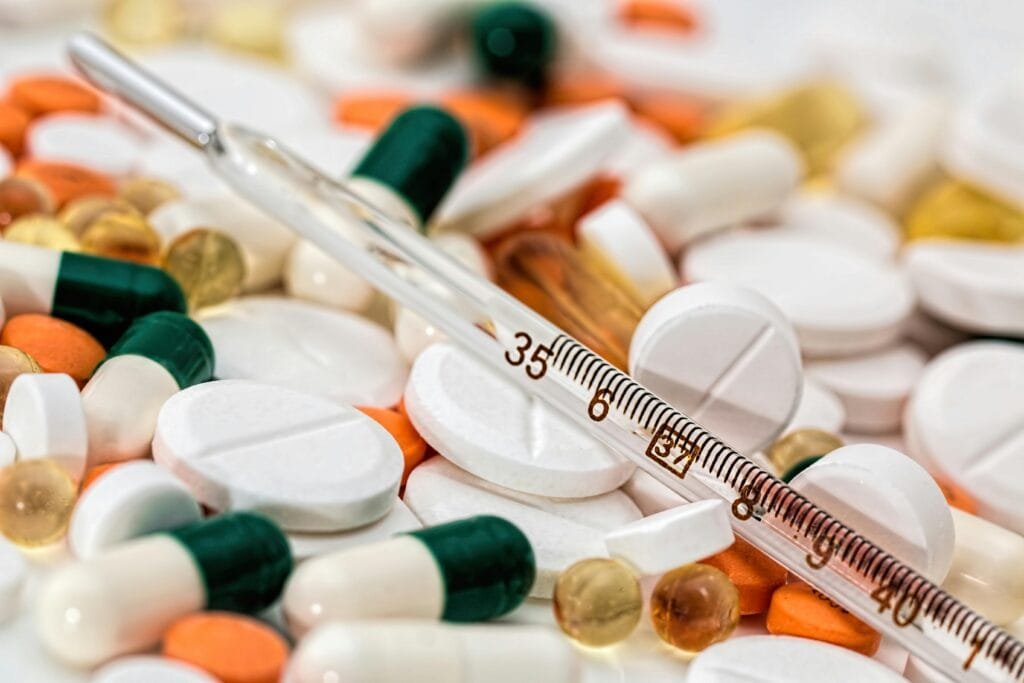 Understanding Histamine: How It Affects Your Body 2 Close-up image showing various pills and a thermometer, emphasizing health and medicine.